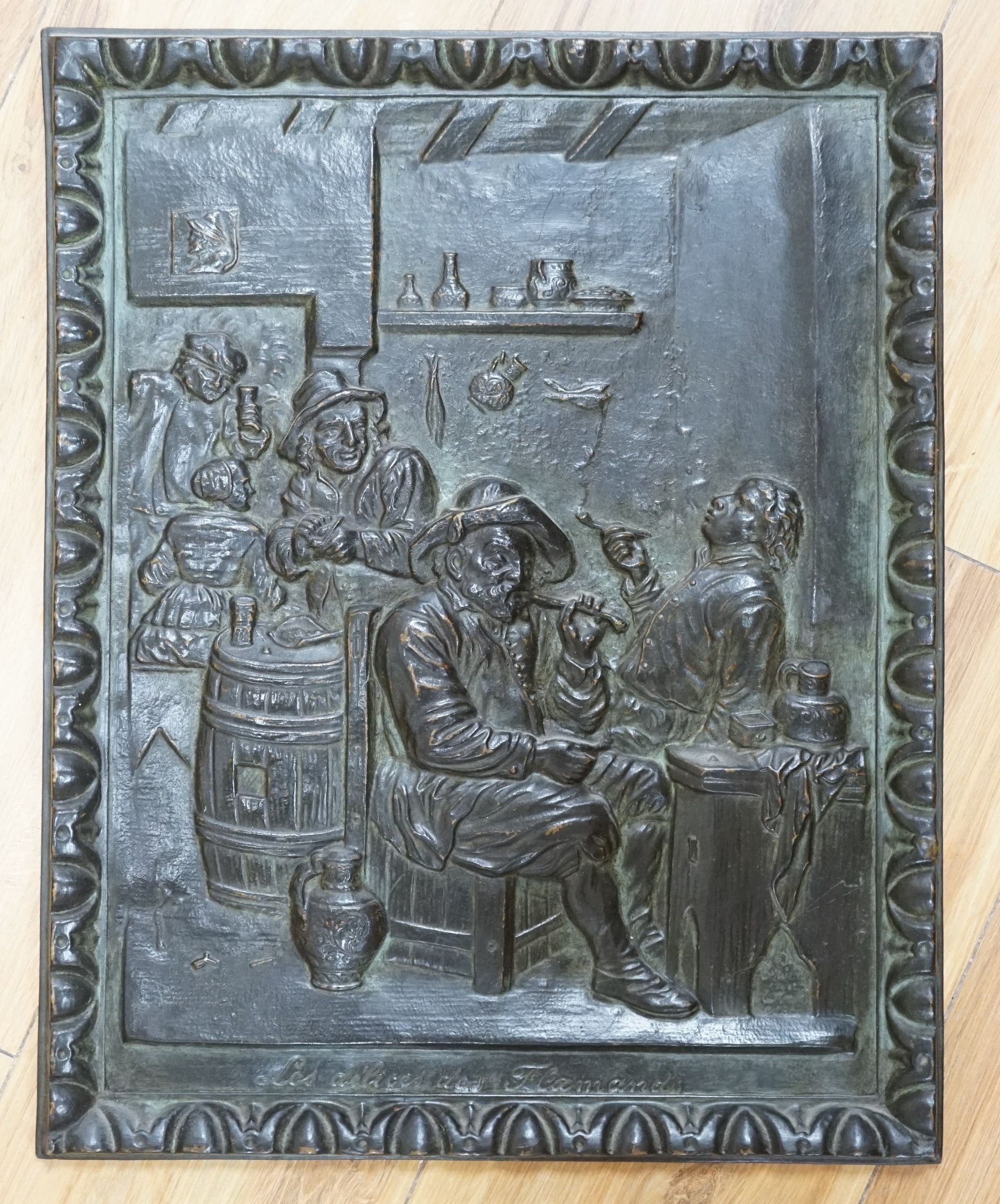 Nine relief plaques, a carved panel and a bronze style putti mounted on wooden panel